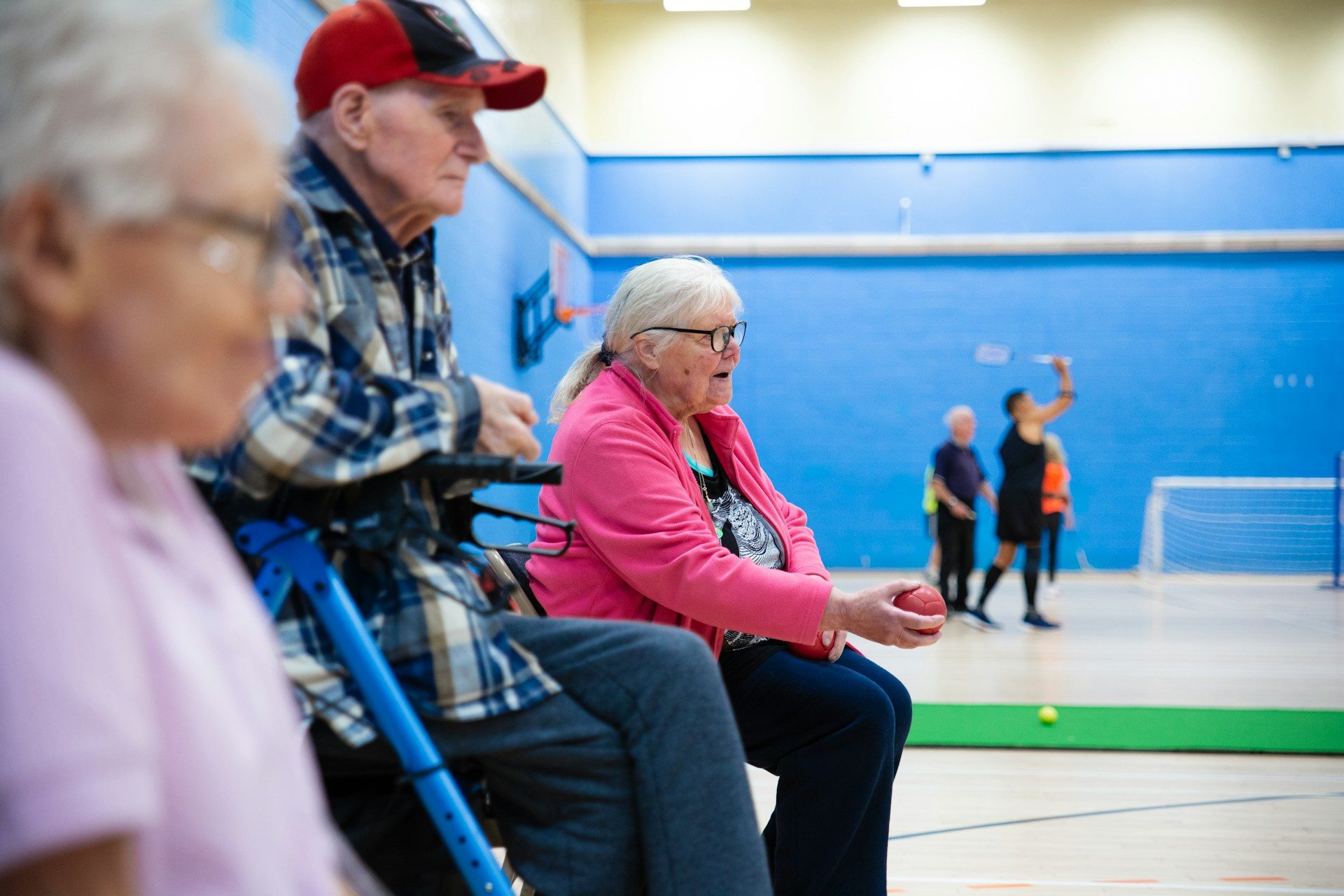 Older people taking part in a sports session at a community sports hall