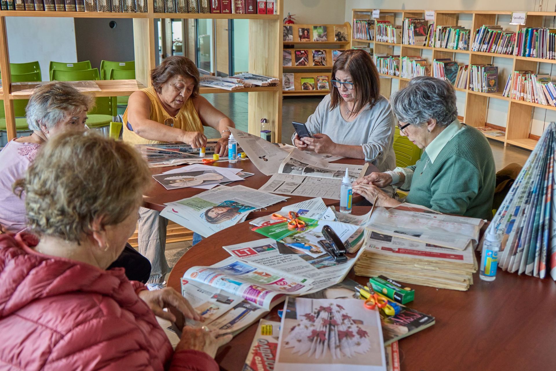A group of older people doing crafts together around a table