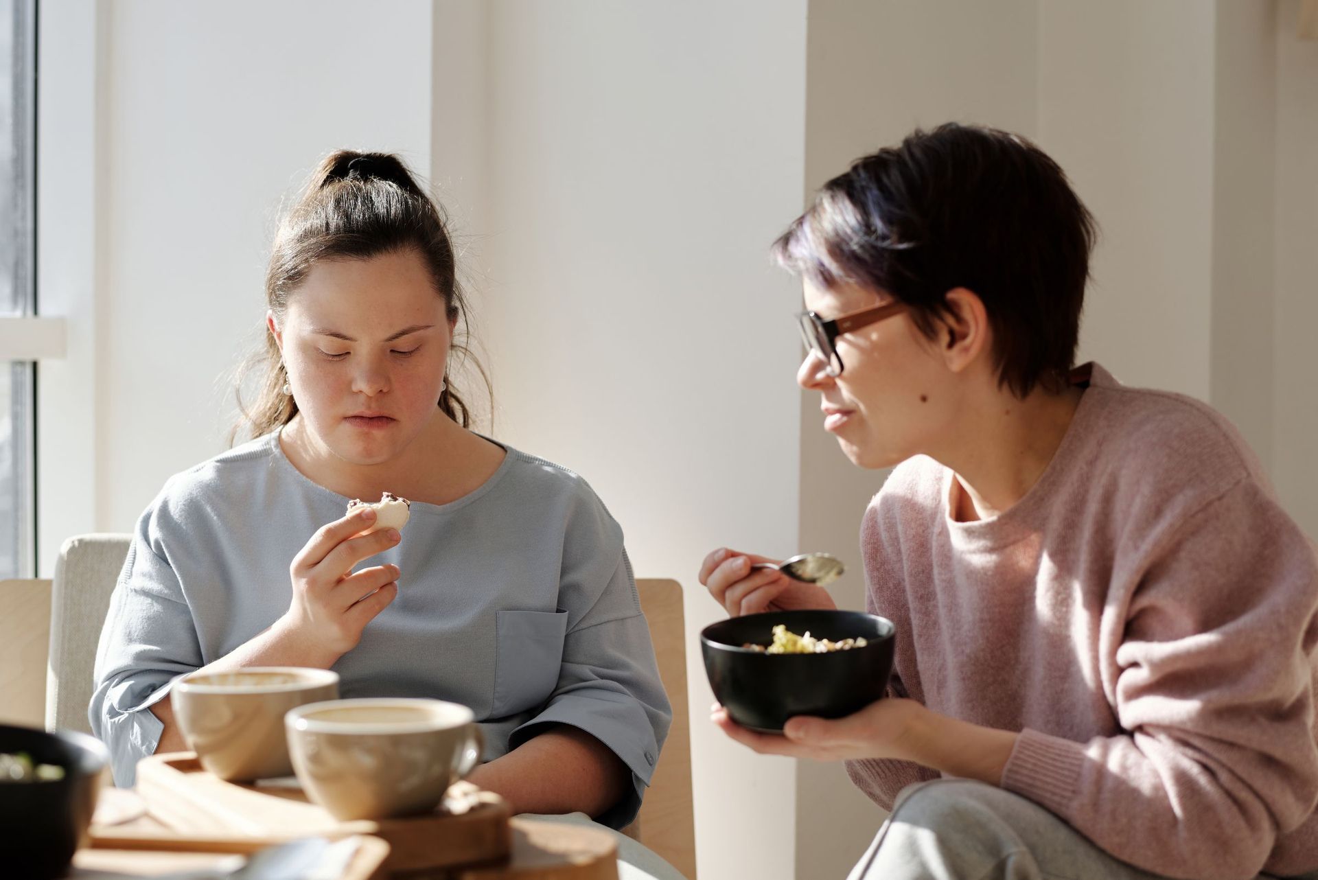 Two women sharing breakfast at a table