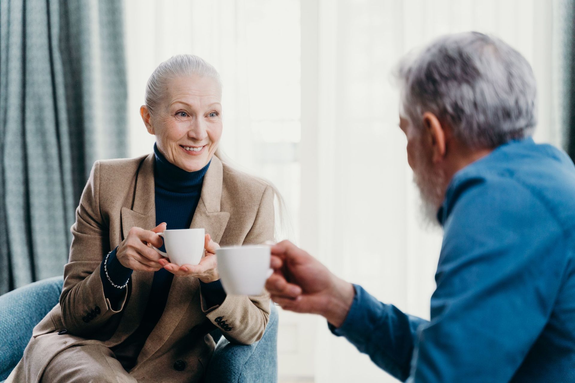 An older couple sharing tea and conversation at home